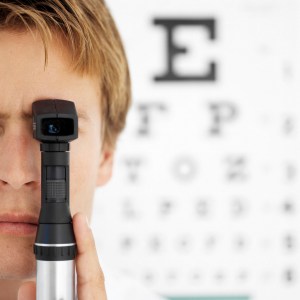 Young Male Optometrist Holding An Ophthalmoscope